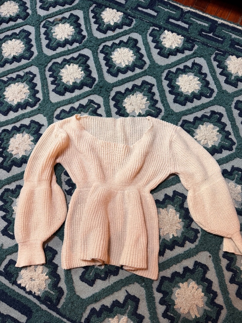 Soft cream knit sweater with a flattering peplum waist. Feminine square neckline